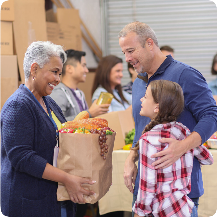 Family receiving groceries at donation center.