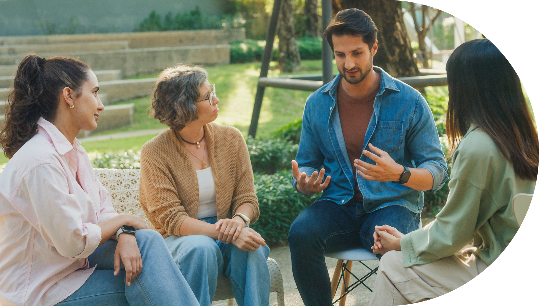 Group discussion outdoors with four people seated.
